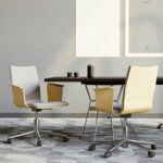 Conference chairs with light wood finish and gray upholstery, placed at the meeting table.