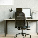 Computer chair with headrest and mesh back in a modern office.