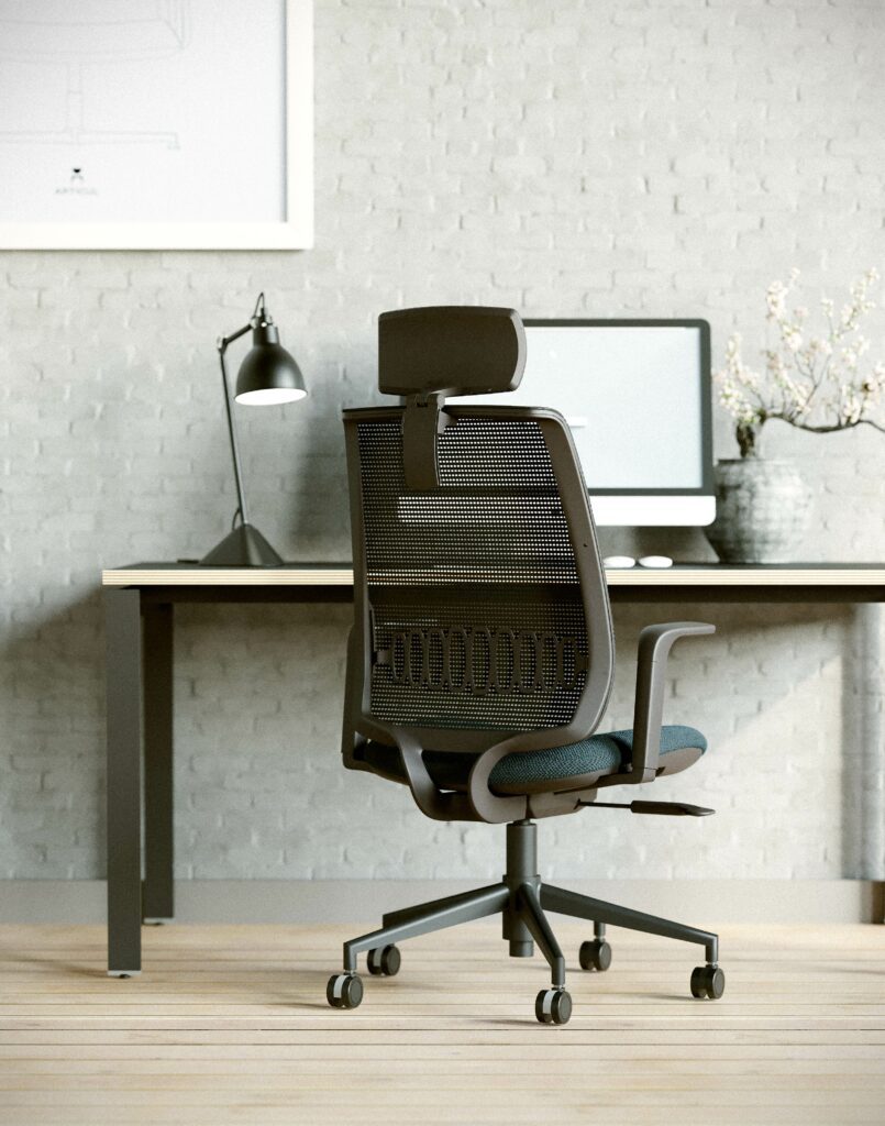 Computer chair with headrest and mesh back in a modern office.